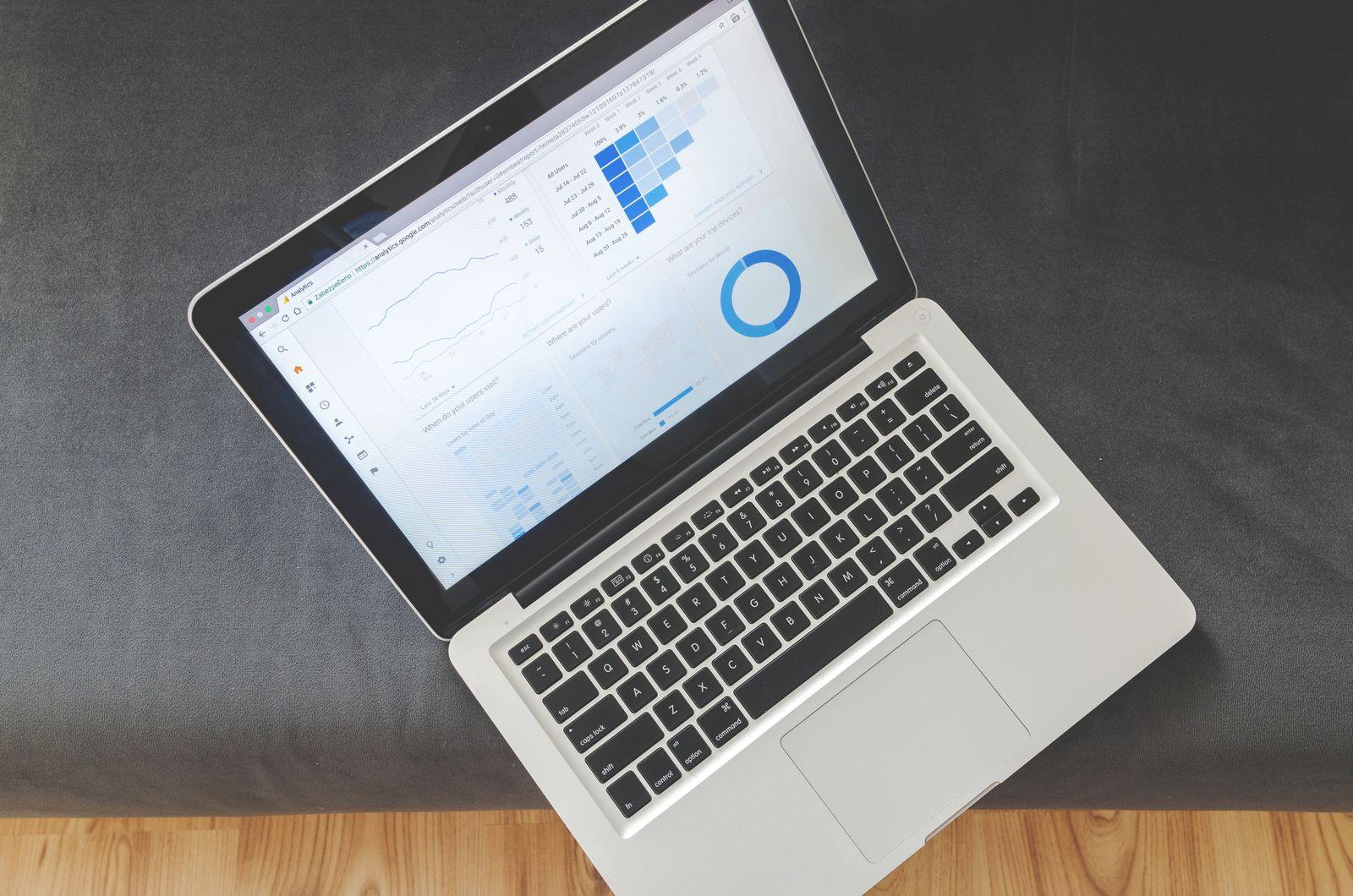 An overhead view of a laptop showing data visualizations and charts