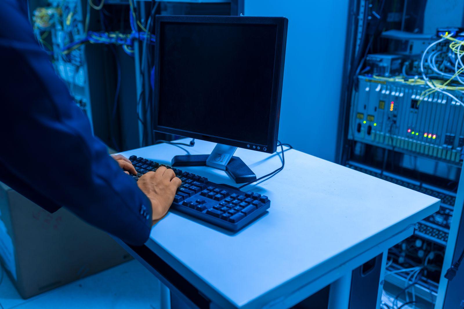 An IT professional monitoring network systems in a server room
